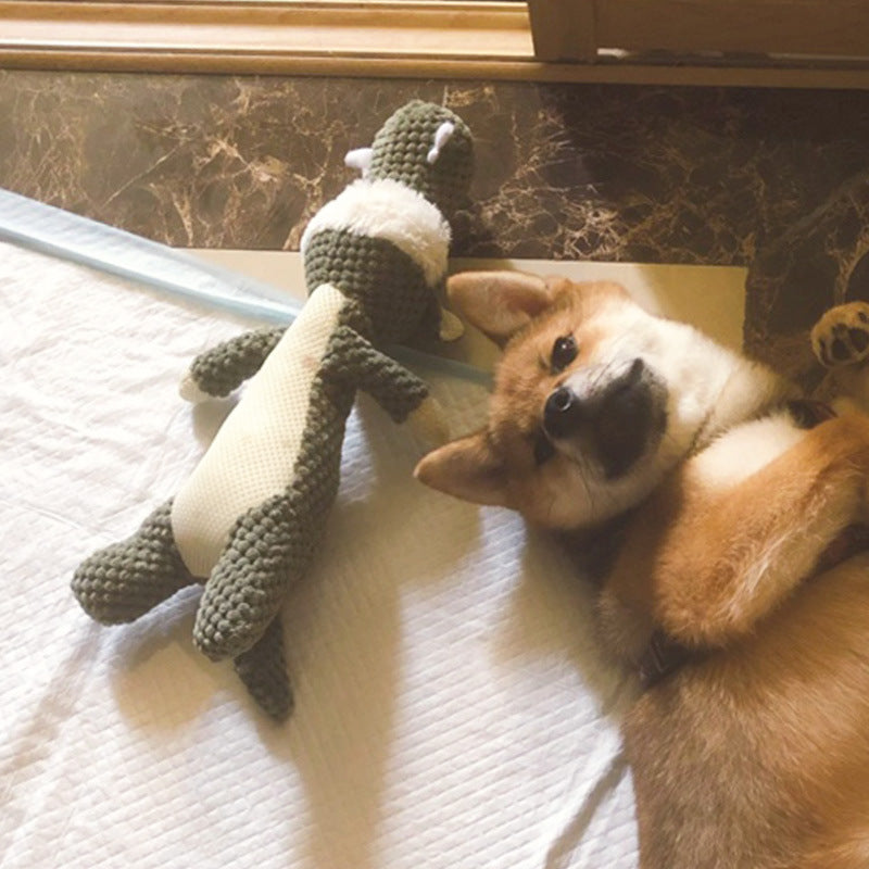 Shiba Inu dog lying next to Brighty Wild wolf squeaky plush toy – soft corduroy interactive dog toy | Brighty Paws
