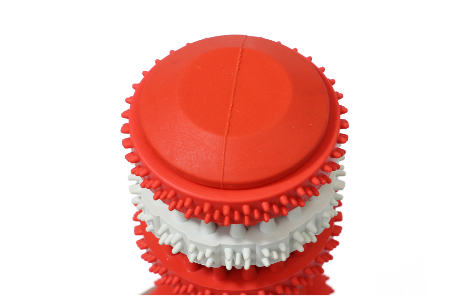 Brighty ChewBar red rubber dental chew toy close-up showing textured nubs for dog teeth cleaning