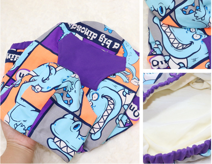 Brighty DinoWarm cozy dog hoodie interior soft fleece lining and colorful dinosaur pattern close-up