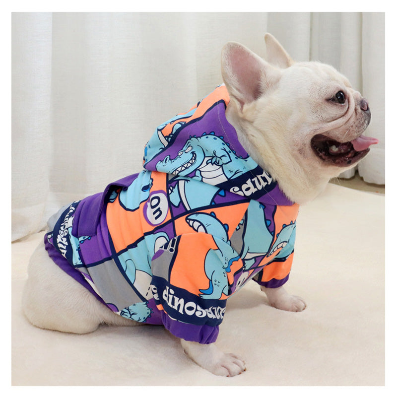 French Bulldog wearing Brighty DinoWarm purple dinosaur hoodie with hood up showing cartoon dino print